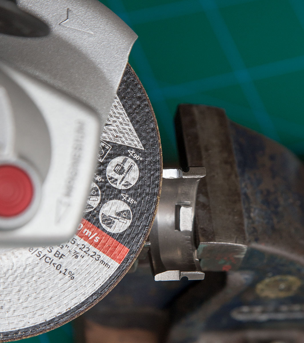 Half of brake cylinder mounted in vise and cut with angle grinder