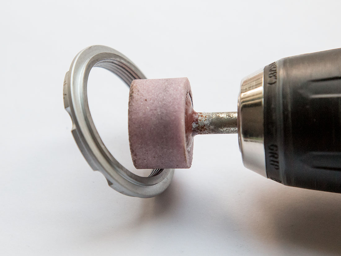 Grinding a bevel on sprocket carrier threads
